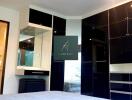 Modern bedroom with black built-in wardrobes