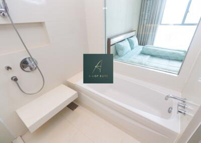 Modern bathroom with a bathtub, shower, and window view