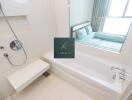 Modern bathroom with a bathtub, shower, and window view