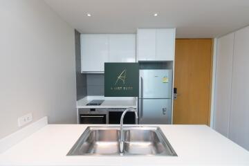 Modern kitchen with stainless steel appliances and white cabinetry