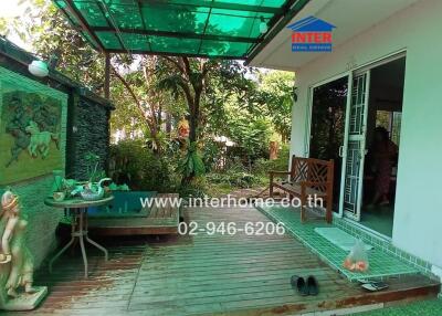 Outdoor patio area with garden view and bench seating