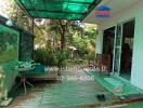 Outdoor patio area with garden view and bench seating