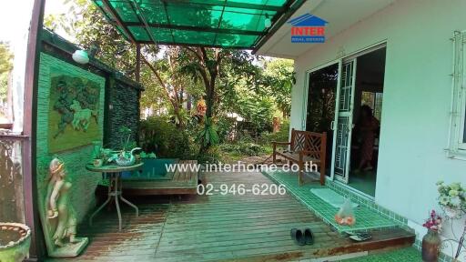 Outdoor patio area with garden view and bench seating