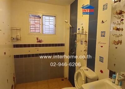 Bathroom with tiled walls and toilet