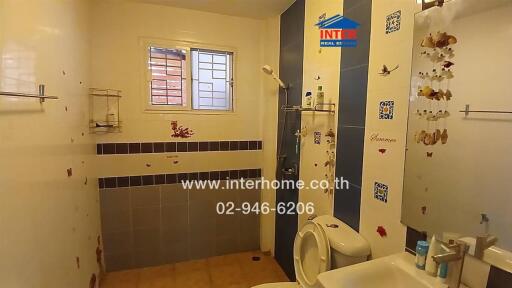 Bathroom with tiled walls and toilet