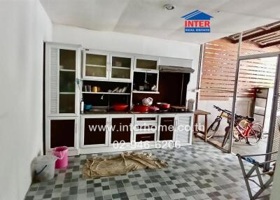 Kitchen with cabinets and open access to an outdoor area