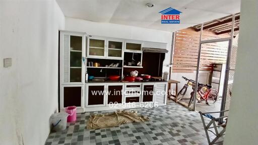 Kitchen with cabinets and open access to an outdoor area