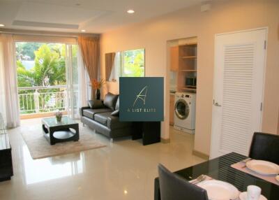 Modern living room with adjacent dining area and view of a green outdoor space