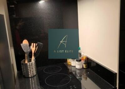 Modern kitchen area with cooking utensils and induction stovetop