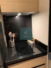 Modern kitchen area with cooking utensils and induction stovetop