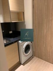 Laundry room with washing machine and wooden cabinets