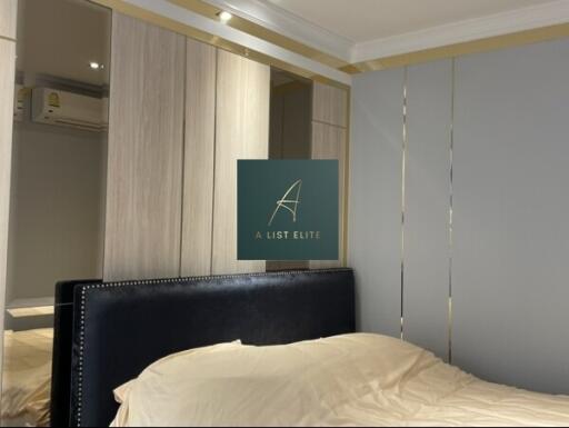 Modern bedroom with fitted wardrobe and upholstered headboard