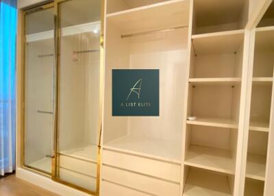 Spacious closet with built-in shelving and sliding doors