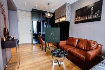 A modern living room with wooden flooring, leather sofa, marble coffee table, and wall art