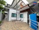 Spacious outdoor area with tiled flooring and seating