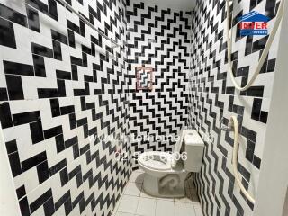 Bathroom with black and white zigzag tile pattern