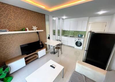 Modern living room and kitchen area with white tiled flooring