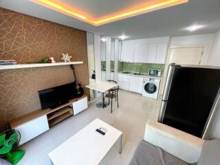 Modern living room and kitchen area with white tiled flooring