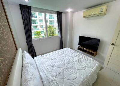 Bedroom with double bed, TV, and air conditioner