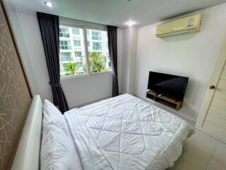 Bedroom with double bed, TV, and air conditioner