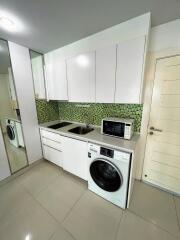 Modern kitchen with tiled backsplash and appliances