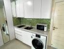 Modern kitchen with tiled backsplash and appliances