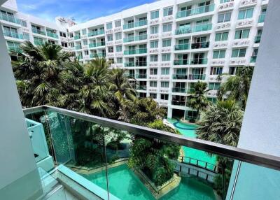 Balcony view of swimming pool and apartment complex