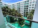 Balcony view of swimming pool and apartment complex