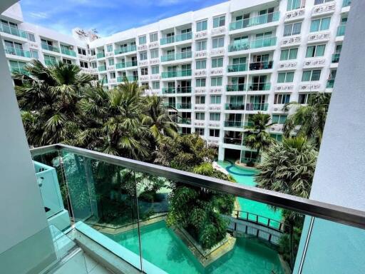 Balcony view of swimming pool and apartment complex