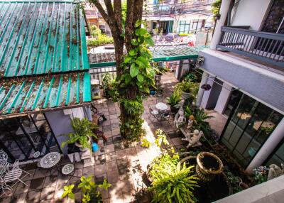 Aerial view of a courtyard with plants and outdoor seating