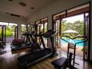 Home gym with exercise equipment and view of swimming pool