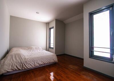 Bedroom with windows and wooden floor