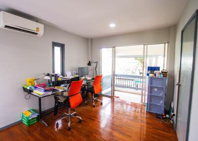 well-lit home office with wooden floors and modern furniture