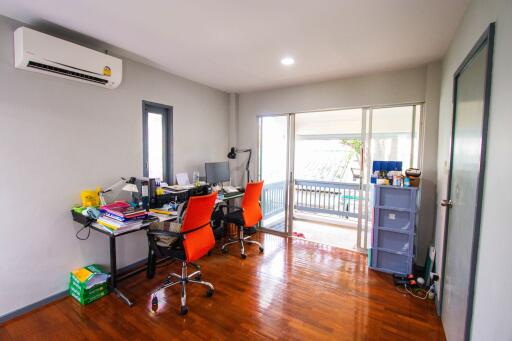 well-lit home office with wooden floors and modern furniture