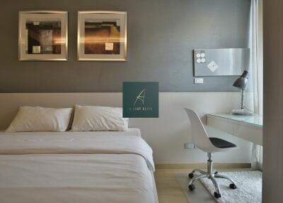 Modern bedroom with bed, wall art, and workspace