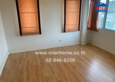 Unfurnished room with wooden flooring and large windows