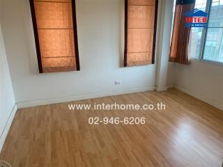 Unfurnished room with wooden flooring and large windows