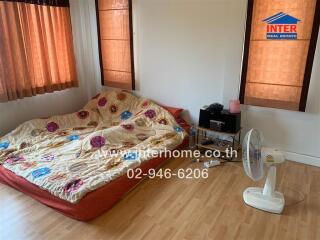 Simple bedroom with mattress on the floor and wooden flooring