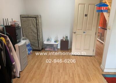 Bedroom with wooden flooring and miscellaneous items