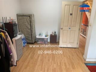 Bedroom with wooden flooring and miscellaneous items