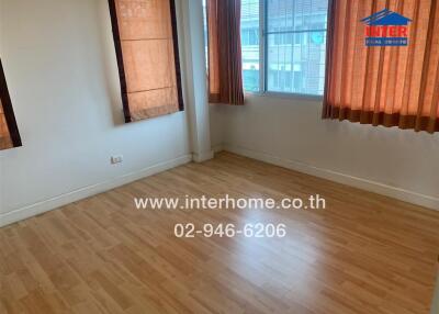 Unfurnished room with wooden floor and large windows