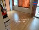 Empty bedroom with wooden flooring and window with orange curtains