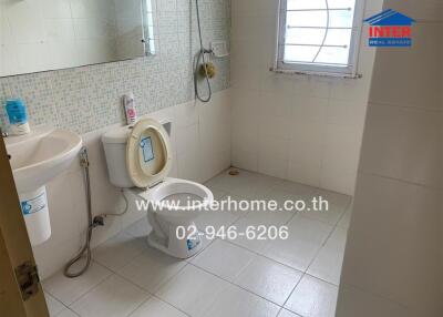 Bathroom with toilet, sink, and shower