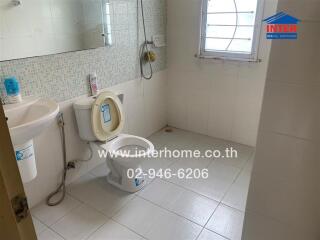 Bathroom with toilet, sink, and shower