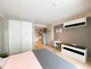 Modern studio apartment with bed, dining area, and kitchen