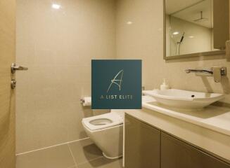 Modern bathroom with sink, toilet, and mirror