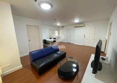 Modern living room with black sofa and TV