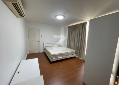 Clean and minimalist bedroom with wooden flooring