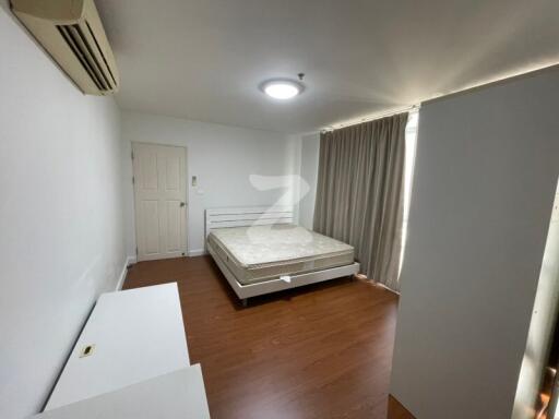 Clean and minimalist bedroom with wooden flooring