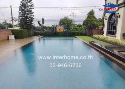 Backyard swimming pool with surrounding patio.